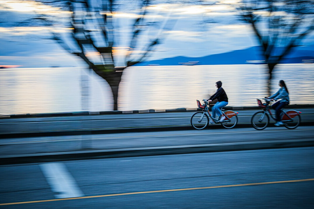 A group of people cycling along a Vancouver waterfront road